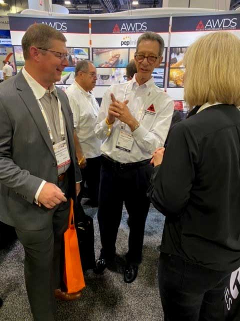 Dave and Melissa explaining antennas in booth at ISC West